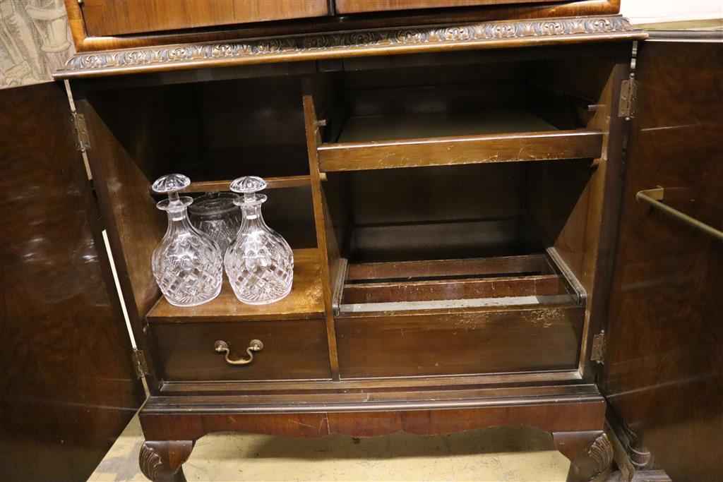 A burr walnut cocktail cabinet, width 81cm, depth 50cm, height 177cm with a collection of Tudor cut glassware